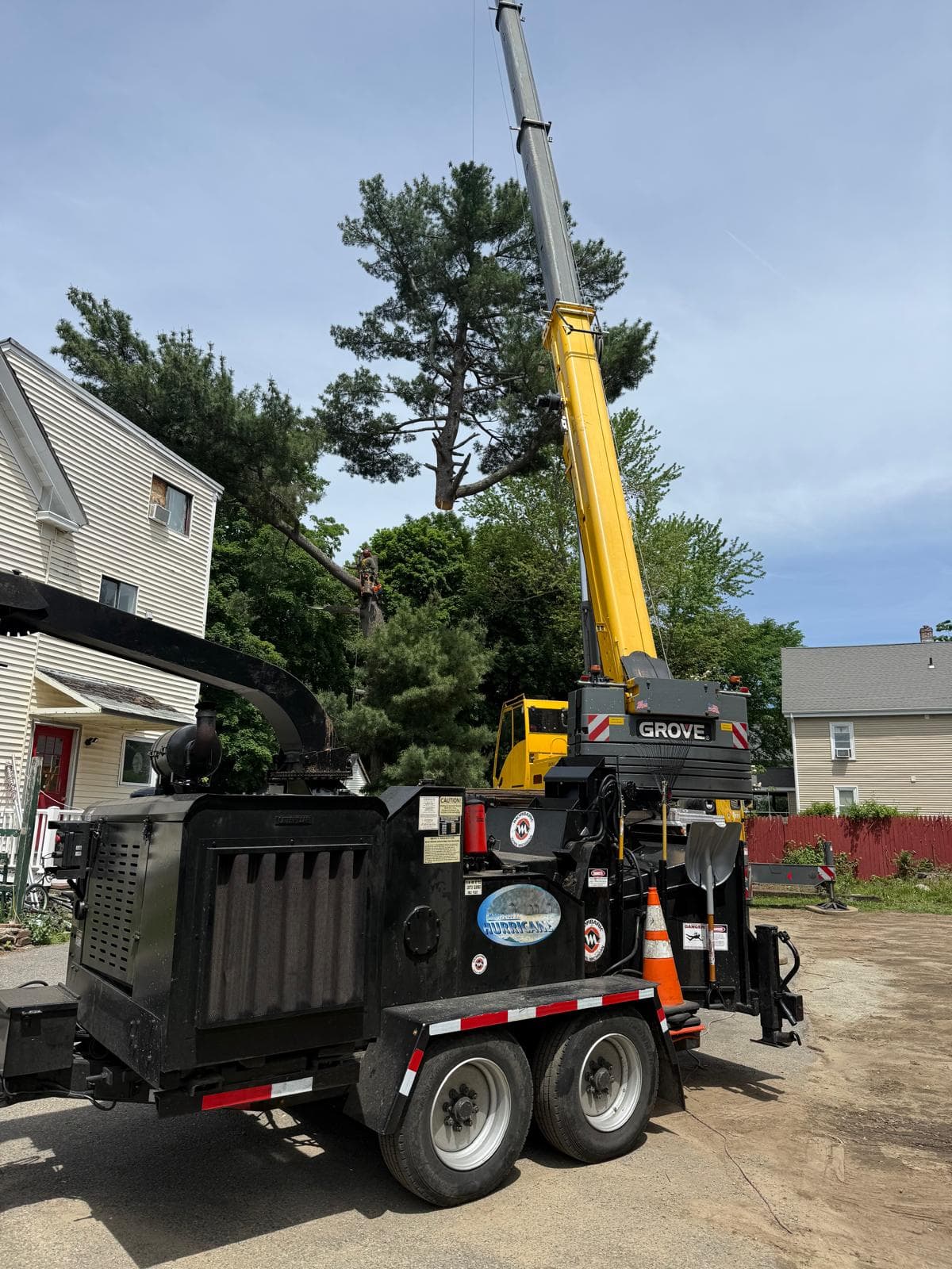 Oak Tree Master crew with crane and wood chipper on a residential job